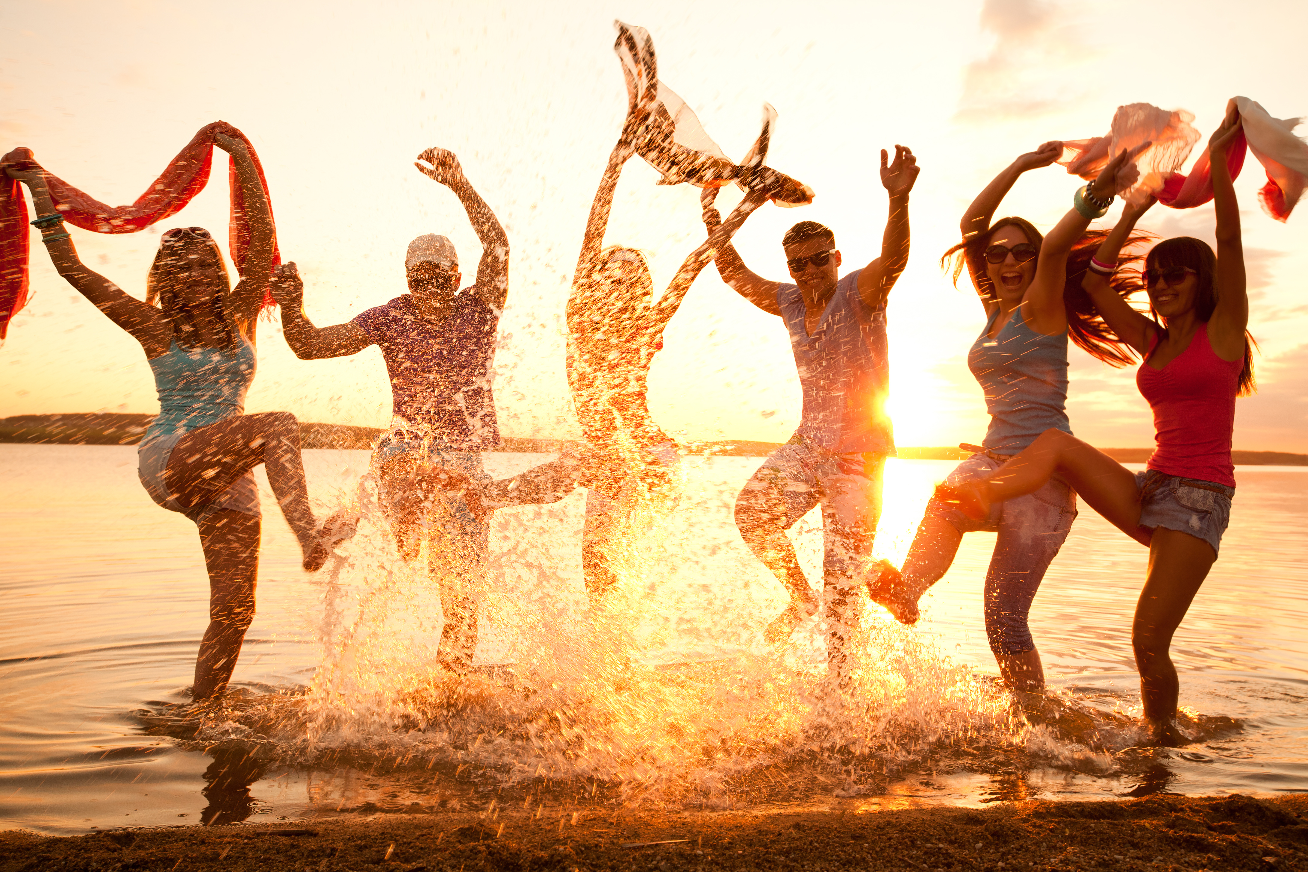 Large group of young people enjoying a beach party